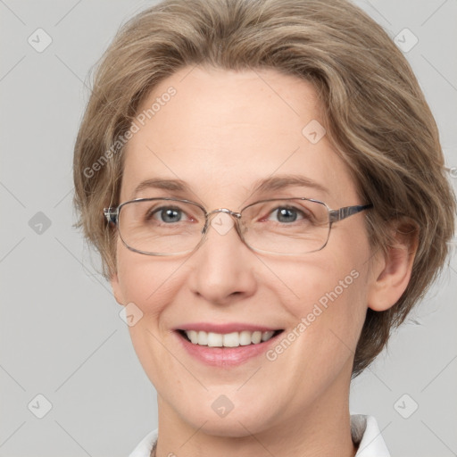 Joyful white adult female with medium  brown hair and grey eyes