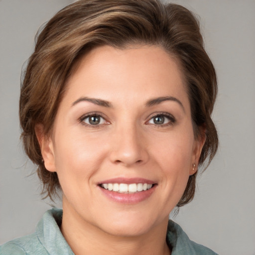 Joyful white young-adult female with medium  brown hair and grey eyes