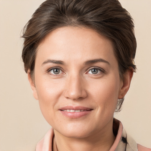 Joyful white young-adult female with medium  brown hair and grey eyes