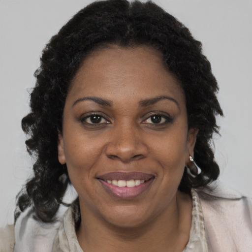 Joyful black young-adult female with medium  brown hair and brown eyes