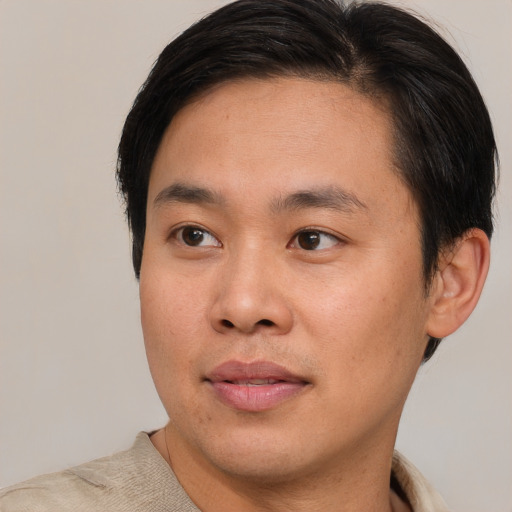 Joyful asian young-adult male with short  brown hair and brown eyes
