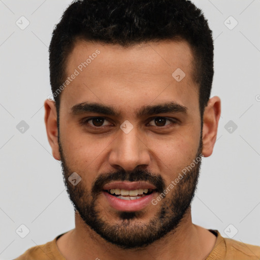 Joyful white young-adult male with short  black hair and brown eyes