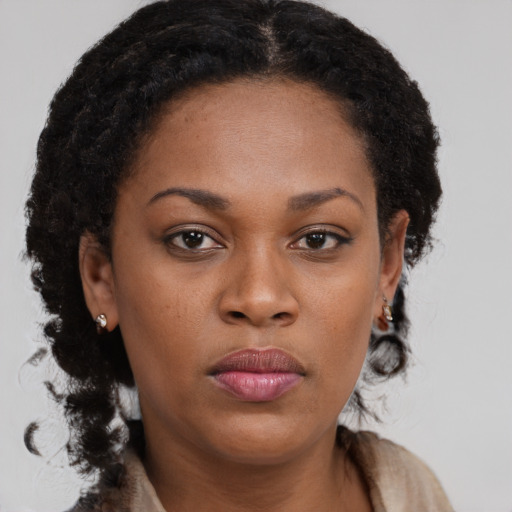 Neutral black young-adult female with long  brown hair and brown eyes