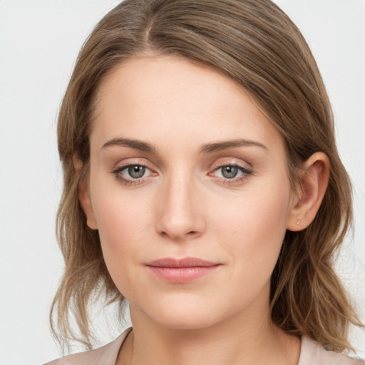 Joyful white young-adult female with long  brown hair and grey eyes