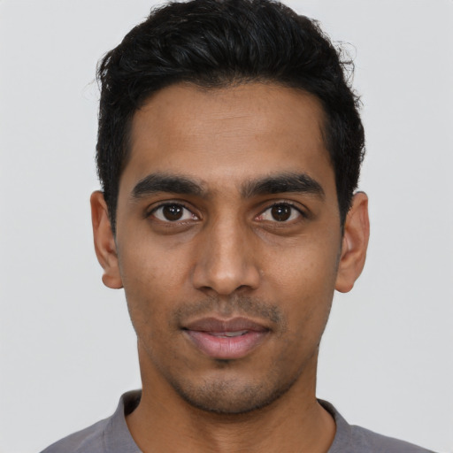 Joyful latino young-adult male with short  black hair and brown eyes