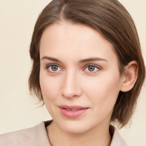 Joyful white young-adult female with medium  brown hair and green eyes