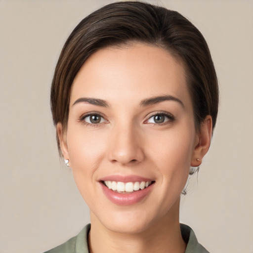 Joyful white young-adult female with medium  brown hair and brown eyes