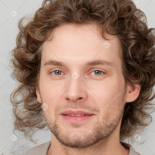 Joyful white young-adult male with medium  brown hair and brown eyes