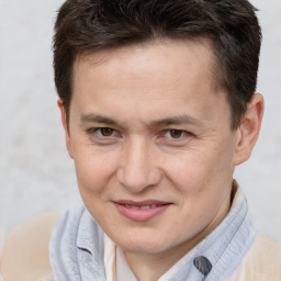 Joyful white adult male with short  brown hair and brown eyes