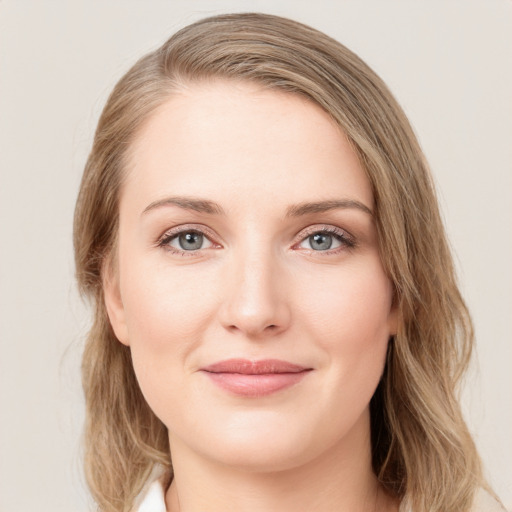 Joyful white young-adult female with medium  brown hair and green eyes