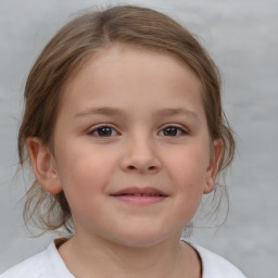 Joyful white child female with medium  brown hair and brown eyes