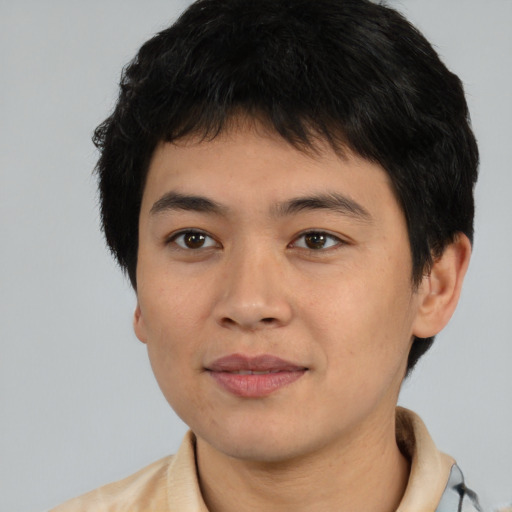 Joyful asian young-adult male with short  brown hair and brown eyes