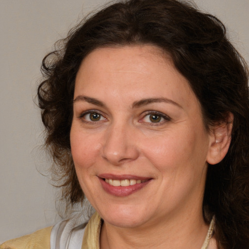 Joyful white adult female with medium  brown hair and brown eyes