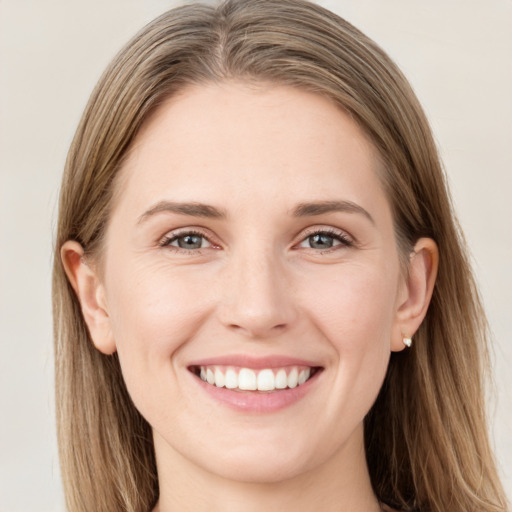 Joyful white young-adult female with long  brown hair and green eyes