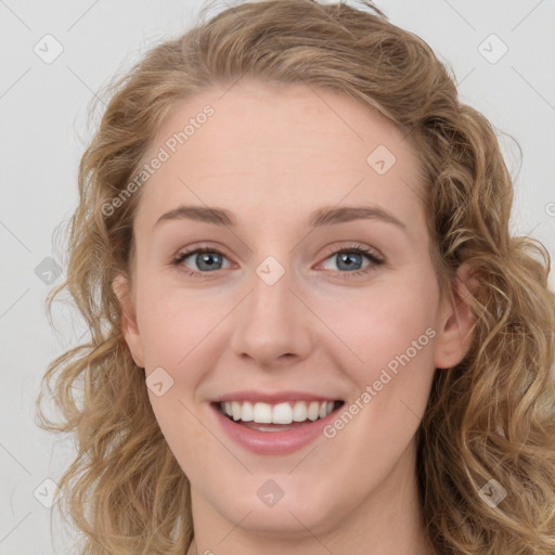 Joyful white young-adult female with long  brown hair and blue eyes