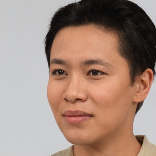 Joyful asian young-adult male with short  black hair and brown eyes