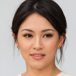 Joyful asian young-adult female with medium  brown hair and brown eyes