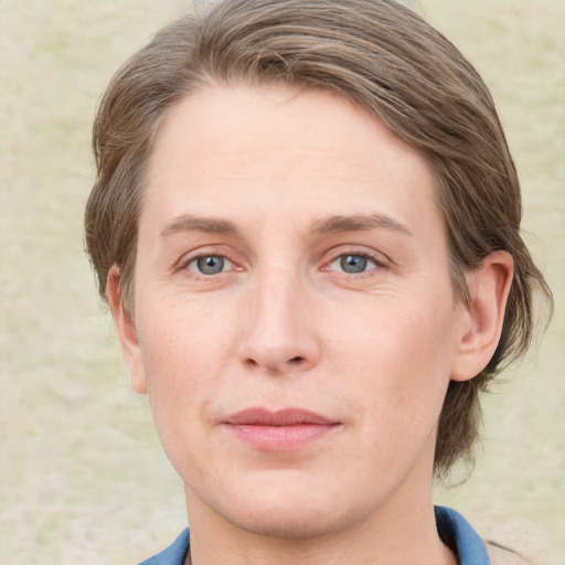 Joyful white young-adult female with medium  brown hair and blue eyes