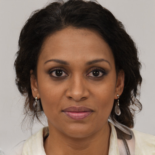 Joyful black young-adult female with medium  brown hair and brown eyes
