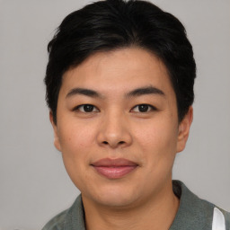 Joyful asian young-adult male with short  black hair and brown eyes