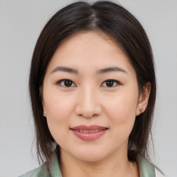 Joyful asian young-adult female with medium  brown hair and brown eyes