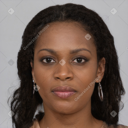 Joyful black young-adult female with long  black hair and brown eyes