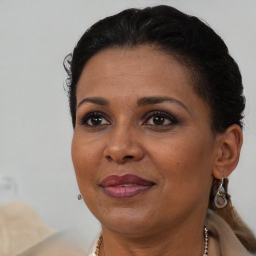 Joyful black adult female with short  brown hair and brown eyes