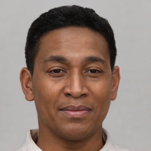 Joyful latino adult male with short  black hair and brown eyes