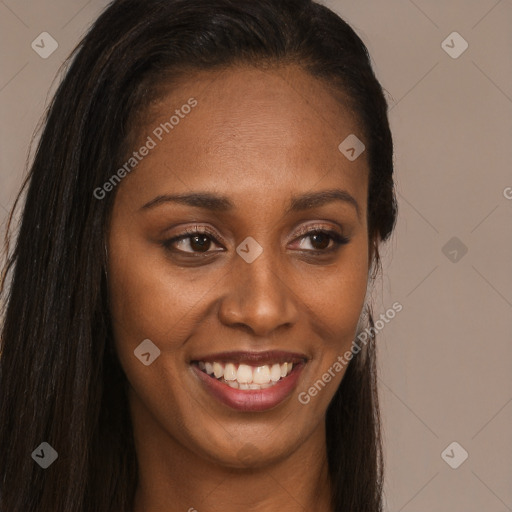 Joyful black young-adult female with long  brown hair and brown eyes