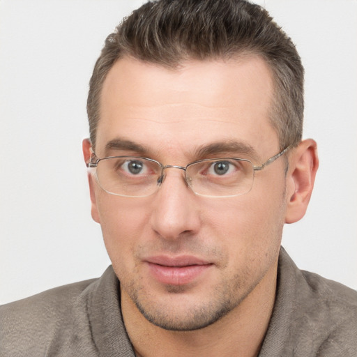 Joyful white adult male with short  brown hair and brown eyes