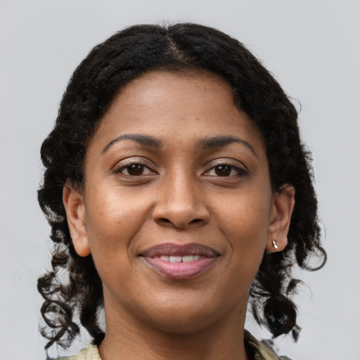 Joyful black young-adult female with medium  brown hair and brown eyes