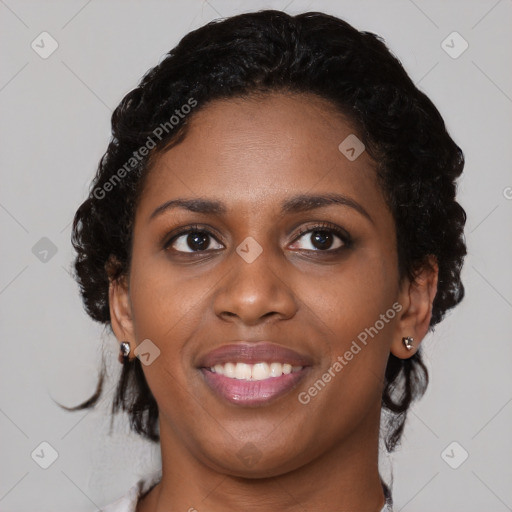 Joyful black young-adult female with medium  brown hair and brown eyes