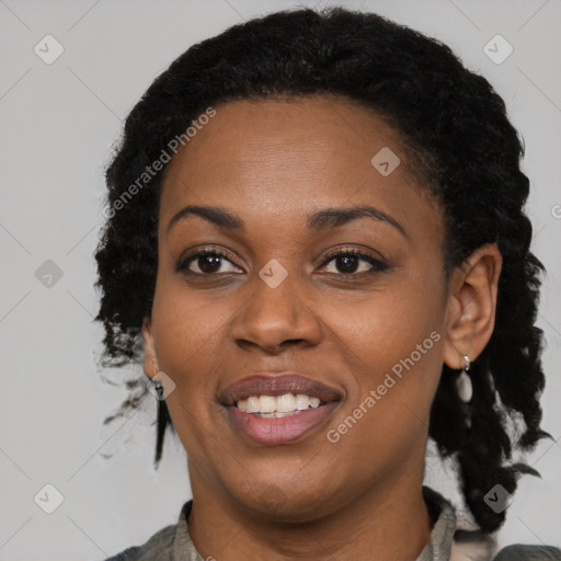 Joyful black young-adult female with long  brown hair and brown eyes