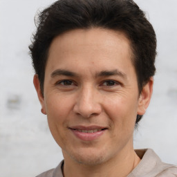 Joyful white adult male with short  brown hair and brown eyes