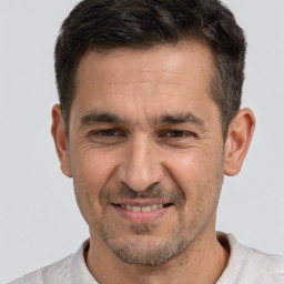 Joyful white adult male with short  brown hair and brown eyes