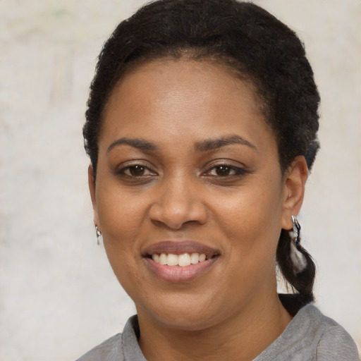 Joyful latino young-adult female with short  brown hair and brown eyes