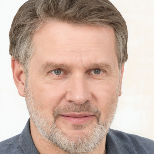 Joyful white middle-aged male with short  brown hair and grey eyes