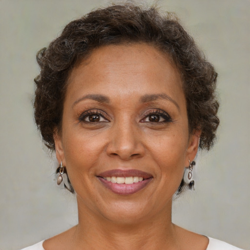 Joyful black adult female with short  brown hair and brown eyes
