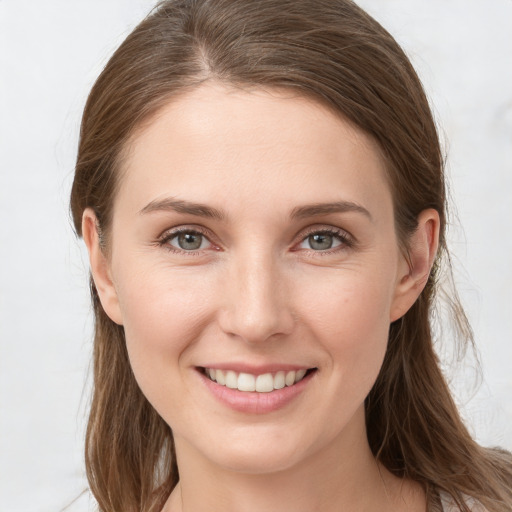 Joyful white young-adult female with long  brown hair and grey eyes