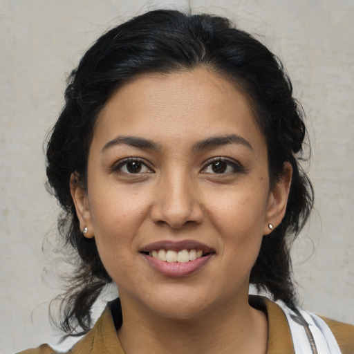 Joyful latino young-adult female with medium  brown hair and brown eyes