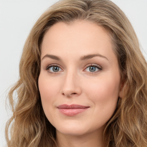 Joyful white young-adult female with long  brown hair and blue eyes