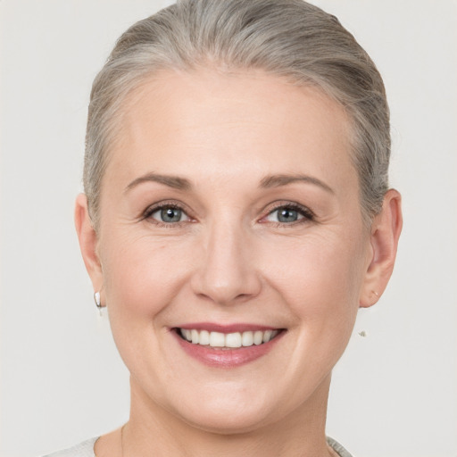 Joyful white adult female with short  brown hair and grey eyes