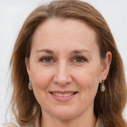 Joyful white adult female with long  brown hair and grey eyes