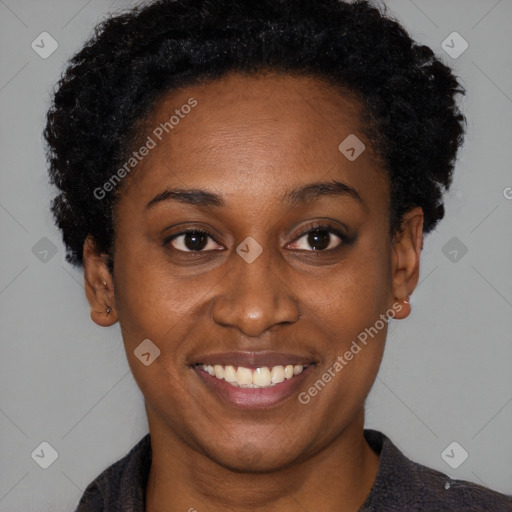 Joyful black young-adult female with short  brown hair and brown eyes