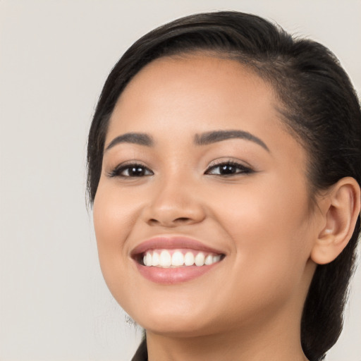 Joyful white young-adult female with long  black hair and brown eyes