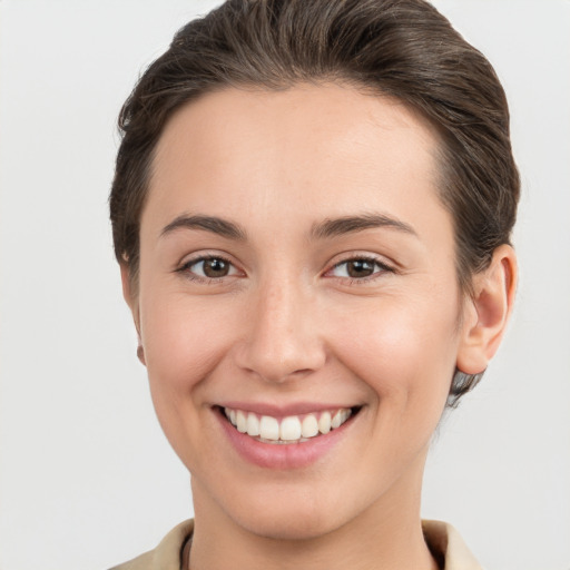 Joyful white young-adult female with short  brown hair and brown eyes