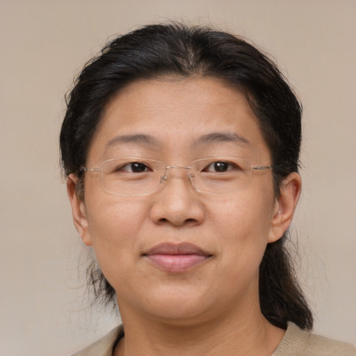 Joyful asian adult female with medium  brown hair and brown eyes