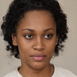 Neutral black young-adult female with medium  brown hair and brown eyes