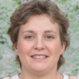 Joyful white adult female with medium  brown hair and green eyes