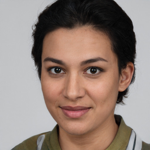 Joyful latino young-adult female with short  brown hair and brown eyes